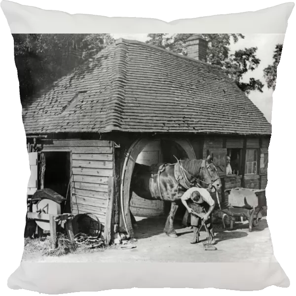 The village blacksmith pursuing his ancient craft in the picturesque village of Claverdon