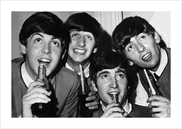 British pop stars The Beatles pose drinking bottles of Coca Cola during a photoshoot