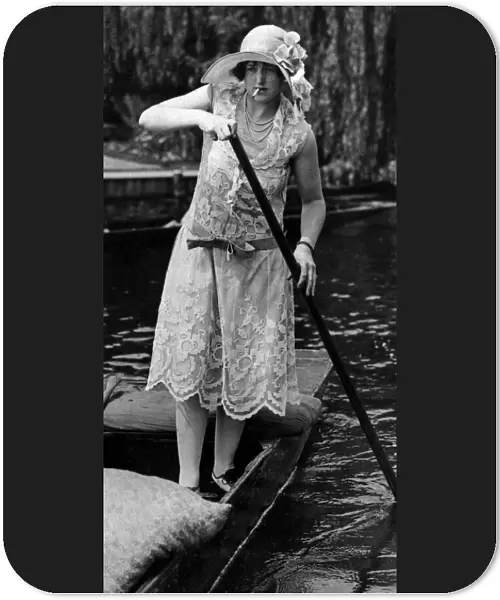 Fashions at Henley Regatta. Woman in a punt, smoking a cigarette. 1926