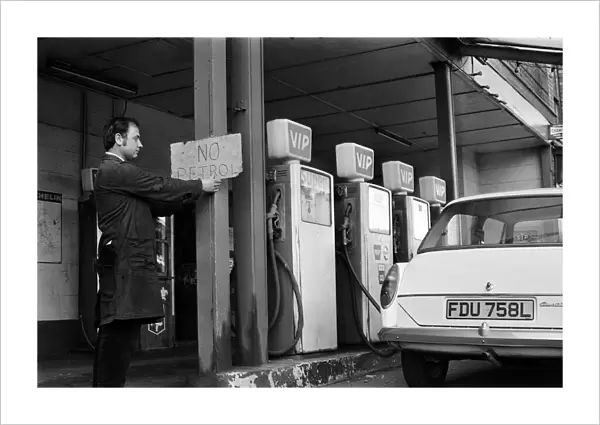 Mechanic Mr Keith Brodrick, putting up a 'No Petrol'