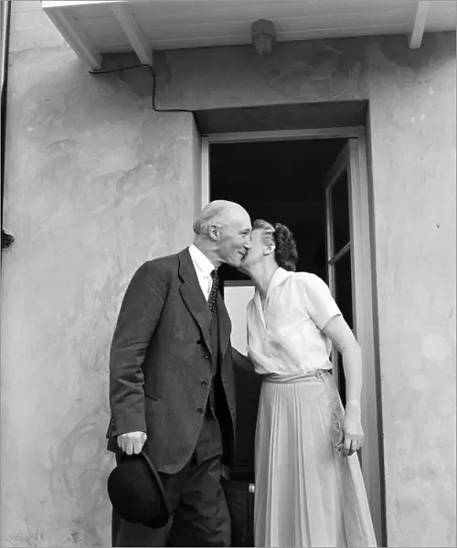 Lord Denning kisses his wife at their home in Whitchurch before leaving for London to