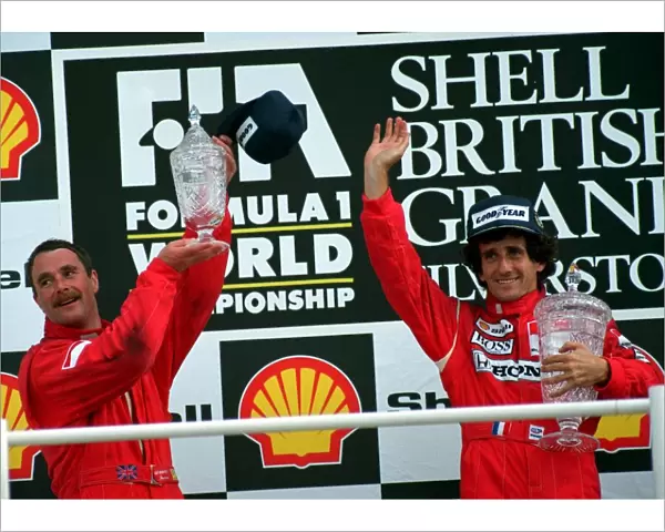 NIGEL MANSELL AND ALAIN PROST ON WINNERS PODIUM AFTER BRITISH GRAND PRIX AT SILVERSTONE