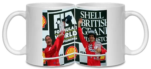 NIGEL MANSELL AND ALAIN PROST ON WINNERS PODIUM AFTER BRITISH GRAND PRIX AT SILVERSTONE