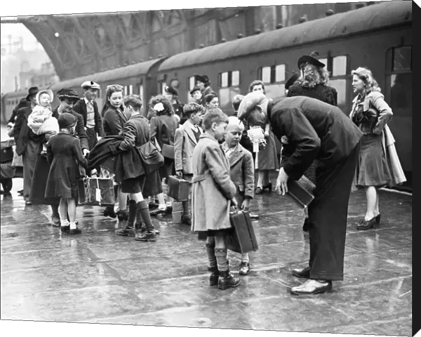 London evacuees return from Suffolk. Parents greeting their children on arrival at St