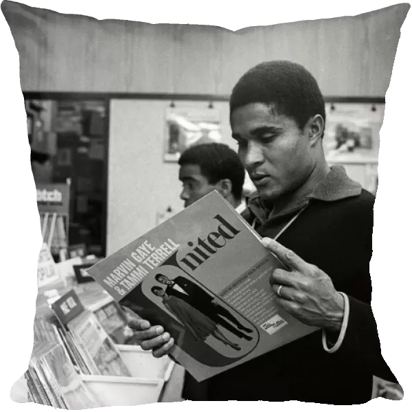 Eusebio, Benfica football player May 1968, looking at a Marvin Gaye record in a shop in