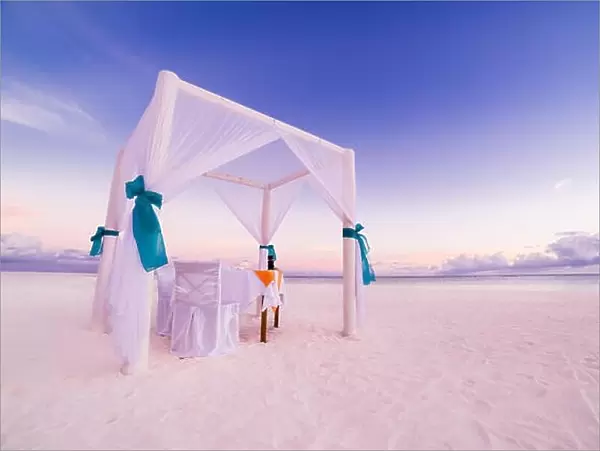 Romantic beach dinner set-up for honeymoon. Beach background concept