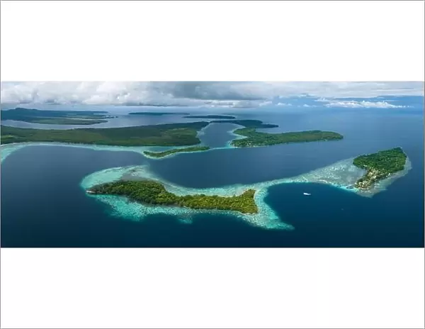 A healthy, robust coral reef surrounds a scenic bay in the Solomon Islands. This beautiful country is home to spectacular marine biodiversity