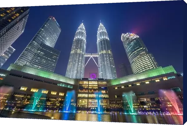 KUALA LUMPUR - SEPTEMBER 14, 2015: The Petronas Towers viewed from KLCC Park at twilight