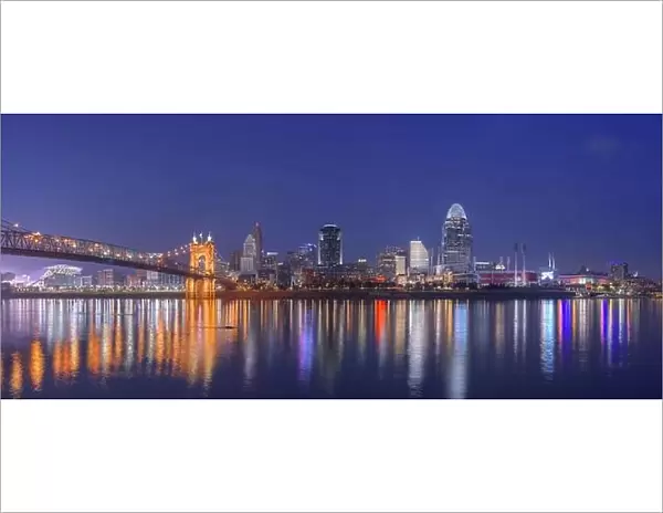 Cincinnati, Ohio, USA downtown skyline and bridge on the river at dusk