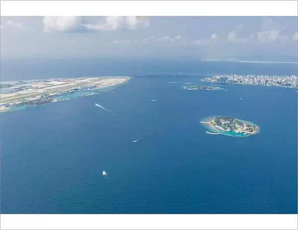 Maldives island capital island, Male. Hulhumale city island view from over the clouds. Aerial landscape in exotic travel destination