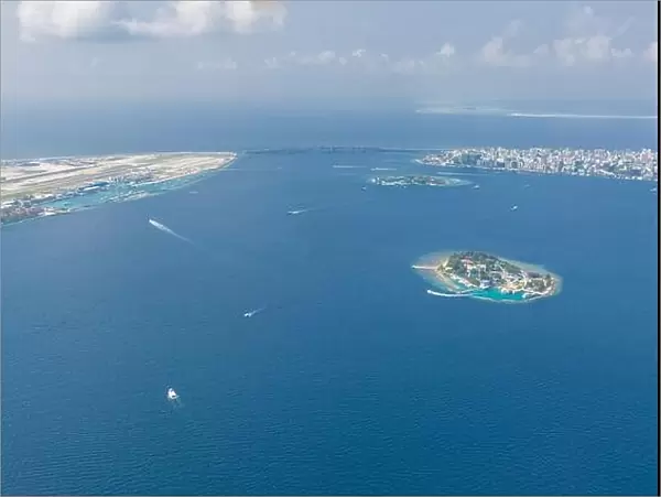 Maldives island capital island, Male. Hulhumale city island view from over the clouds. Aerial landscape in exotic travel destination
