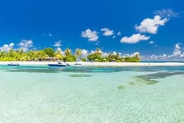 Amazing Maldives island panorama. Luxury beautiful beach scene, palm trees and perfect blue sea water. Relaxing and exotic tropical landscape view