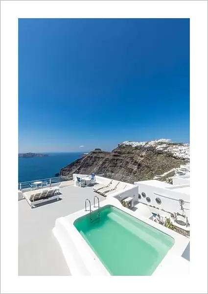 Scenic view of traditional cycladic resort with Jacuzzi in foreground, Oia village, Santorini, Greece. Luxury summer travel destination, vibes, mood