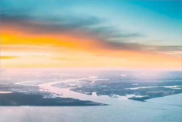 Western Dvina Flows Into The Baltic Sea. River Divides The Northern And Kurzeme District Of Riga, Latvia. View From Airplane Flight. Sunset Sunrise Ov