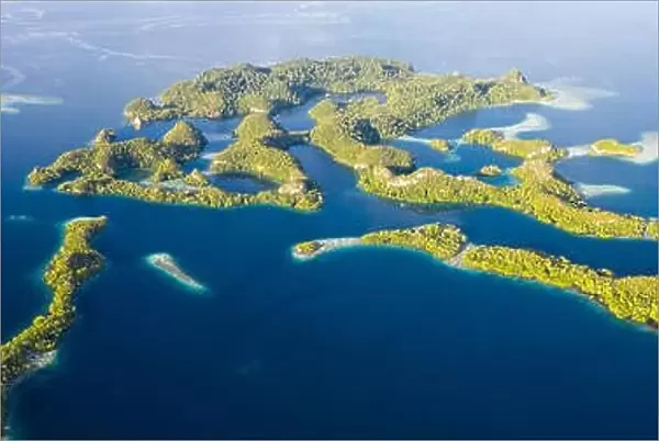 Remote limestone islands rise from the stunning seascape in Raja Ampat, Indonesia. This diverse region is known as the heart of the Coral Triangle