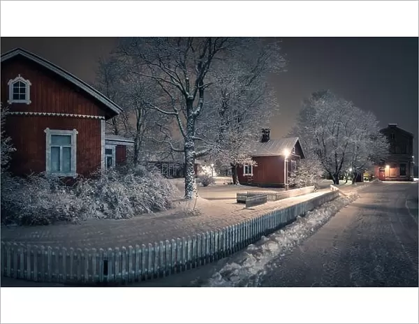 Public park with cozy cafe place and snow covered trees at winter evening in Finland. Cafe place is open only in summertime