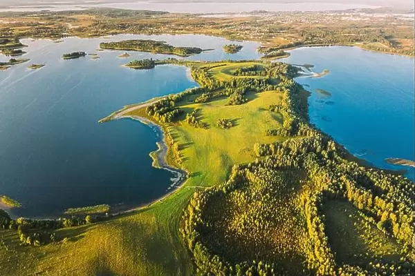 Braslaw Or Braslau, Vitebsk Voblast, Belarus. Aerial View Of Nedrava Lake, Green Forest And Meadow Landscape In Sunny Autumn Morning. Top View Of