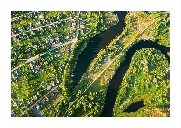 Aerial View Of Calm River And Village In Belarus, Europe. Green Forest Woods Landscape In Sunny Summer Evening. Top View Of Beautiful European Nature