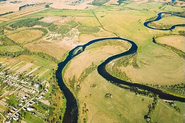Golovintsy, Gomel region, Belarus. Aerial View Green Meadow And Curved River Landscape In Sunny Summer Day. Top View Of Beautiful European Nature From