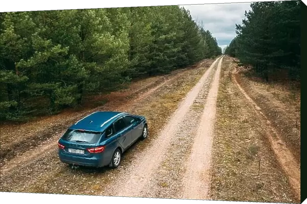 Lada Vesta Parked On Roadside. Country Road Through Forest
