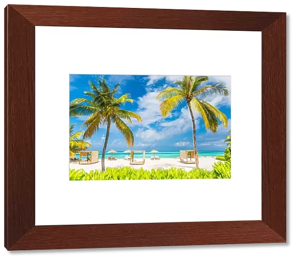 Tropical beach scene, loungers and beach canopy under palm trees and blue sky. Summer vacation and holiday concept