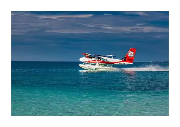 Ari Atoll, Maldives - 05.05.2019: Maldives seaplane on luxury resort, wooden jetty loading the plane, ready for departure. Tropical island background