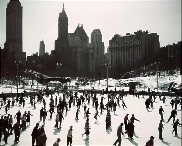1950s LARGE NUMBER OF PEOPLE ICE SKATING ON WOLLMAN RINK CENTRAL PARK MANHATTAN NEW YORK CITY USA