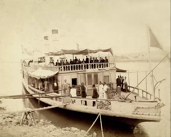 Ship moored at Hawamdiek, in Egypt, with a group of illustrious people on board