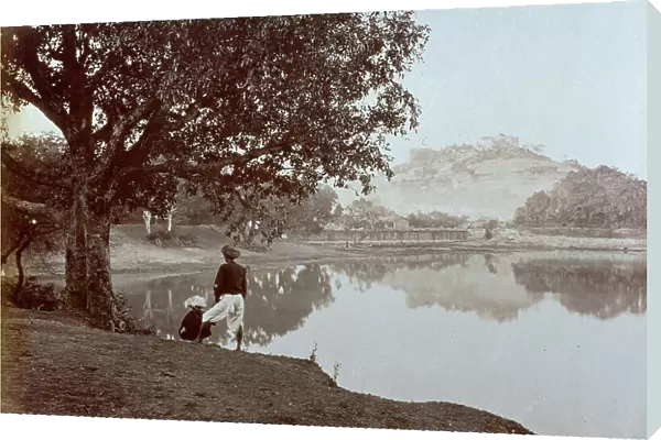 View of the lake of Pune, or Poona as the English call it. In the foreground two adolescents wearing the typical indian headdress