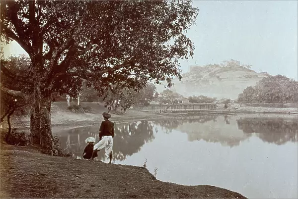 View of the lake of Pune, or Poona as the English call it. In the foreground two adolescents wearing the typical indian headdress