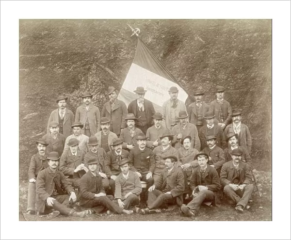 Group of workers in a lignite mine in Castelnuovo. They are wearing civilian clothing. Behind them an italian flag can be seen