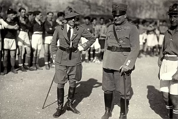 Gabriele D'Annunzio and a high army officer pose together with the soldiers, who wear a sport uniform. The image was taken during the city occupation of Fiume by part of the Italian legionary troops, headed by Gabriele D'Annunzio