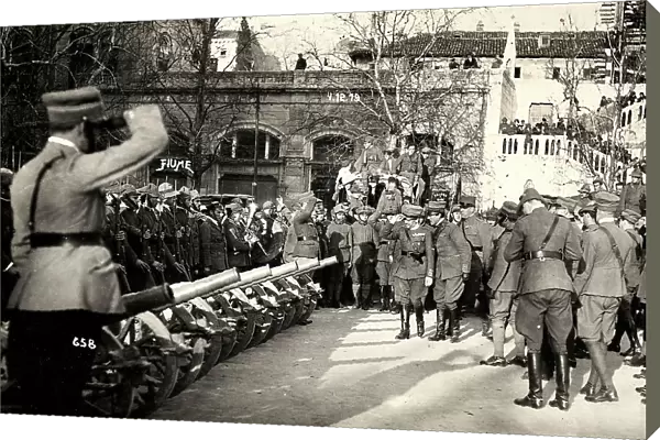 A group of officers reviews the troops, in a line with the artillery pieces. The photograph was taken during the occupation of Fiume by part of the Italian legionary troops, headed by Gabriele D'Annunzio