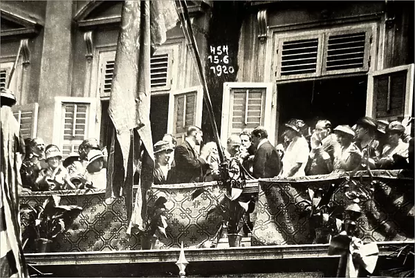 Gabriele D'Annunzio talks with a group of people on the balcony of a palace. The photograph was taken during the occupation of Fiume by part of the Italian legionary troops, headed by the poet