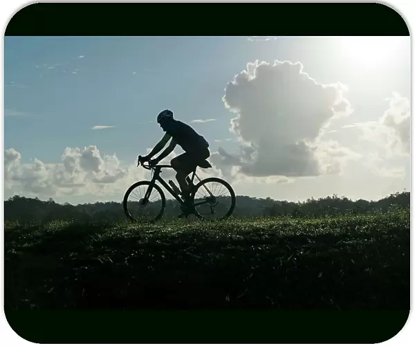 Silhouette of man riding bicycle