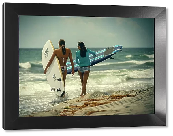 2 female surfers at the beach