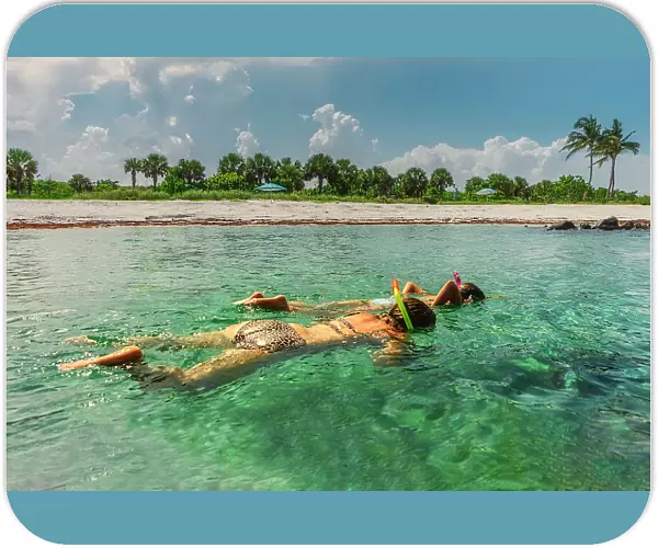 Florida, Peanut Island, girls snorkeling in crystal clear water