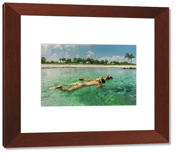 Florida, Peanut Island, girls snorkeling in crystal clear water
