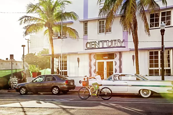 Florida, South Beach, person riding bicycle in front of Century Hotel