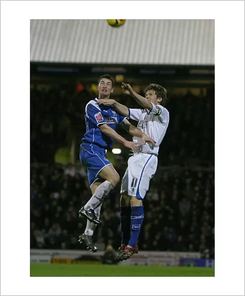 Dean Hammond challenges Oldhams Gary MacDonald in the air