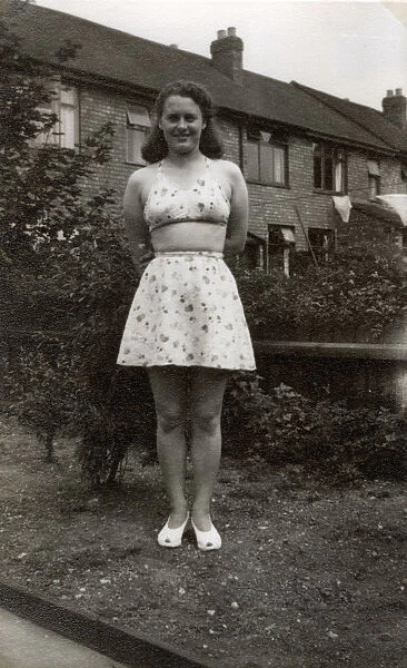 1940s - Lay poses in back garden in new beachwear