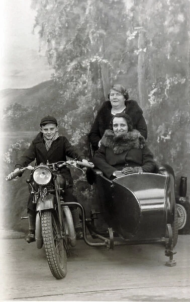 Boy & ladies on a 1929 Coventry Eagle in a studio
