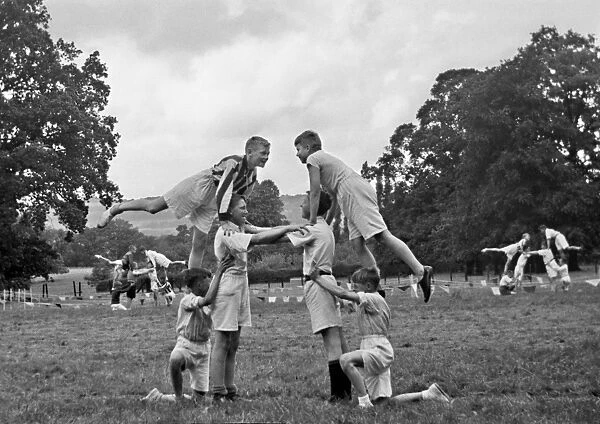 Boys doing acrobatics in a field