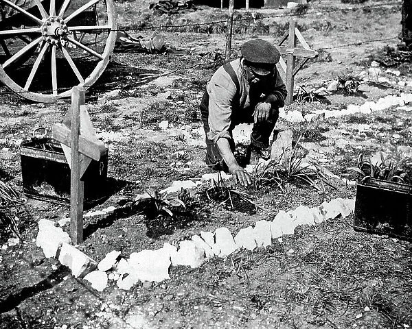 British soldier tending grave of fallen colleague, WW1