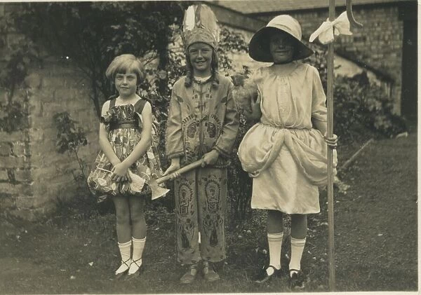 Three children in fancy dress, one as Little Bo-Peep, another as a Native American