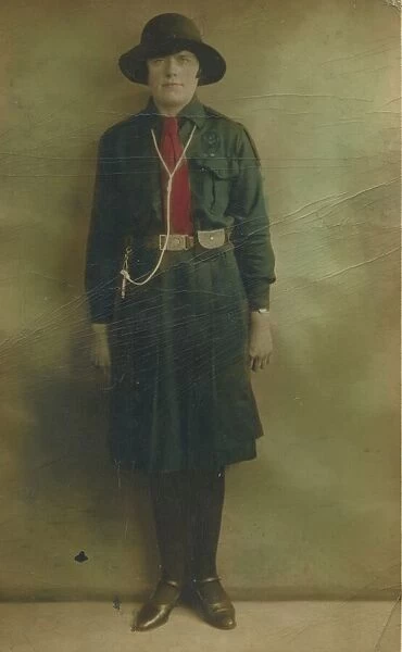 Colour photograph of a girl guide in uniform. Date: c. 1930
