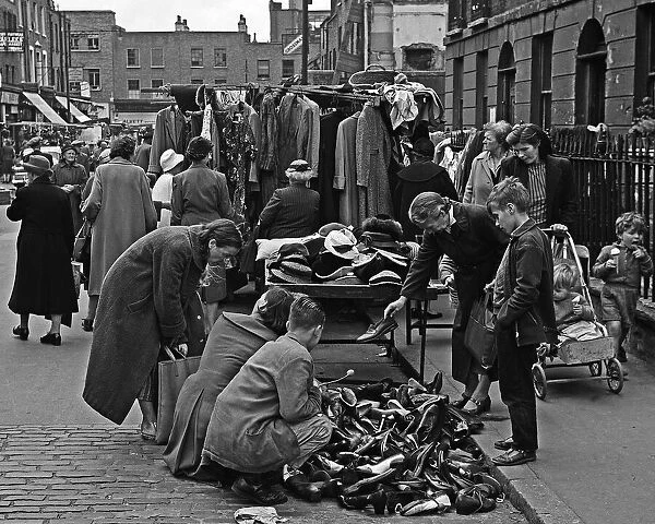 Family sorting shoes in Berwick Street Market, London