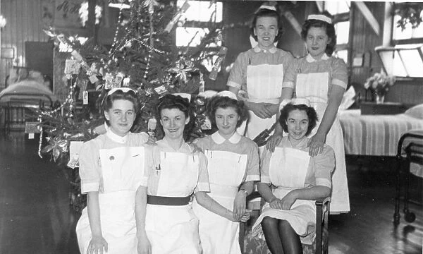 Group of nurses and Christmas tree