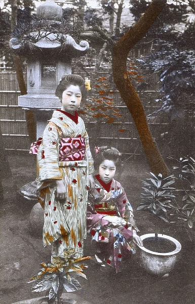 Japan - Two Geisha Girls - posing in an ornamental garden