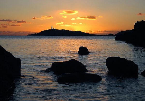 The lighthouse on Little Ross Island flashes at sunset